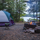 Campsite with a fire and a tent on a trout lake in northern Minnesota at dusk - PhotoDune Item for Sale