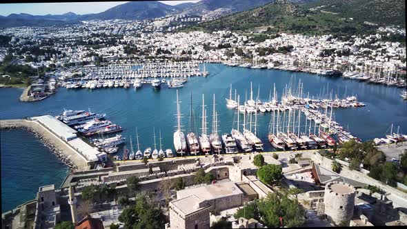 Amazing panoramic view from drone of full of yachts Bodrum harbour and ancient Kalesi castle. alt