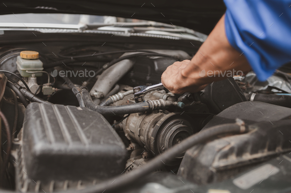 Car mechanic is inspecting the engine of a car coming in for repair at the center. Professional engi - Stock Photo - Images