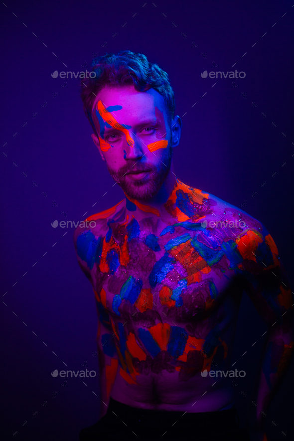 Portrait of a men in a futuristic cyberpunk style in neon clothes. A  high-tech man