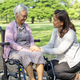 Caregiver help and care Asian senior woman patient sitting and happy on wheelchair in park. - PhotoDune Item for Sale