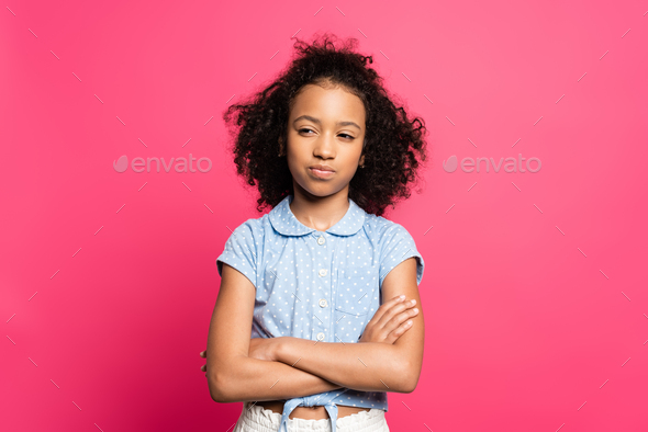 pensive cute curly african american kid with crossed arms isolated on pink  Stock Photo by LightFieldStudios