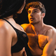 Muscular Man Touching And Looking At Sexy Woman In Lace Bra Isolated On  Black Stock Photo, Picture and Royalty Free Image. Image 154311791.
