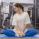 Woman stretching sitting on the mat in the gym - PhotoDune Item for Sale