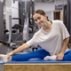 Cheerful woman stretching in an indoor gym - PhotoDune Item for Sale