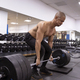 Strong man doing deadlifts in a gym - PhotoDune Item for Sale