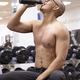 Vertical photo of tired man drinking water in the gym - PhotoDune Item for Sale