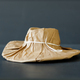 A brand new hat wrapped in rustic beige craft paper. Black Friday shopping concept. - PhotoDune Item for Sale