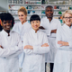 A team of experts in the lab coats are standing in an apothecary. - PhotoDune Item for Sale