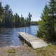 Sparkling blue water in a lake with a typical Minnesota state forest dock - PhotoDune Item for Sale