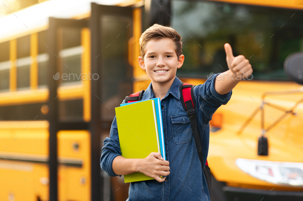 Smiling Preteen Boy Standing Near Yellow School Bus And Showing Thumb ...