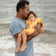 Father holding toddler daughter in his arms at the beach in Florida - PhotoDune Item for Sale