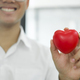 Man holding red heart shaped rubber. - PhotoDune Item for Sale