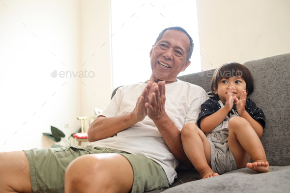 Grandpa Watching TV with Grandchild