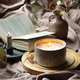 Home still life with a candle and a book in bed. - PhotoDune Item for Sale