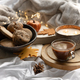 Autumn composition with a cup of coffee, cookies and candles in bed. - PhotoDune Item for Sale