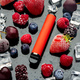 Electronic cigarette with berries and ice cubes on black background - PhotoDune Item for Sale