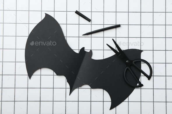 Scissors and paper bat on light background, top view Stock Photo by  AtlasComposer