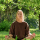meditation Woman meditates in nature outdoor.At ground level, a relaxed woman meditates and breathes - PhotoDune Item for Sale