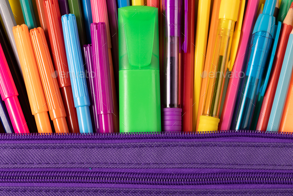 Imagine of colorful pens, markers, crayons in pencil box on yellow  background Stock Photo by Wavebreakmedia
