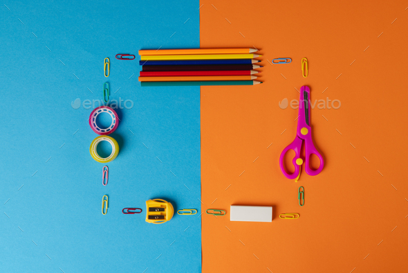 Vertical composition of post its, eraser, crayons and scissors on blue  surface with copy space Stock Photo by Wavebreakmedia