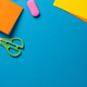 Vertical composition of post its, eraser, crayons and scissors on blue  surface with copy space Stock Photo by Wavebreakmedia