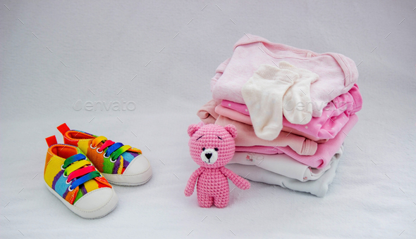 Children's things on a light background. The concept of baby clothes - Stock Photo - Images