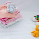 Children&#39;s things on a light background. The concept of baby clothes - PhotoDune Item for Sale