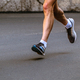 close-up legs male runner running on gray asphalt marathon race - PhotoDune Item for Sale