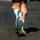 close-up sole running shoe and legs male runner, background dark road, marathon race - PhotoDune Item for Sale
