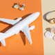 Modern minimalist handmade jewelry on orange and beige. Air plane toy for delivery and parcels on - PhotoDune Item for Sale