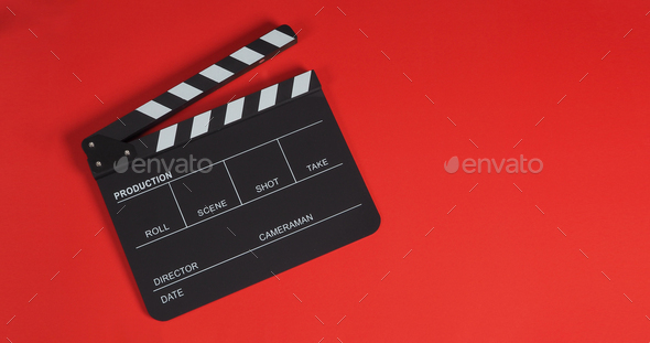 Clapper board on red background.