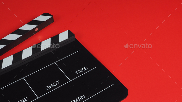 Clapper board on red background.