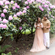 Sensual pregnant couple in blossom garden. Future parents in blooming rhododendron park. - PhotoDune Item for Sale