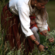 Midsummer celebration countryside- woman wearing national costume collect medicinal plants on field - PhotoDune Item for Sale