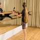 Female ballet dancer practicing at barre in dance studio - dance and ballerina concept - PhotoDune Item for Sale