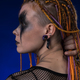 Headshot of young woman with horror stage make up painted on face and orange dreadlocks hairstyle - PhotoDune Item for Sale