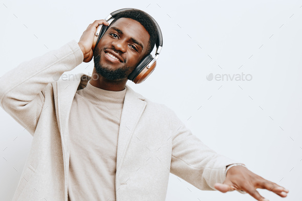 Black man posing with headphones - SuperStock