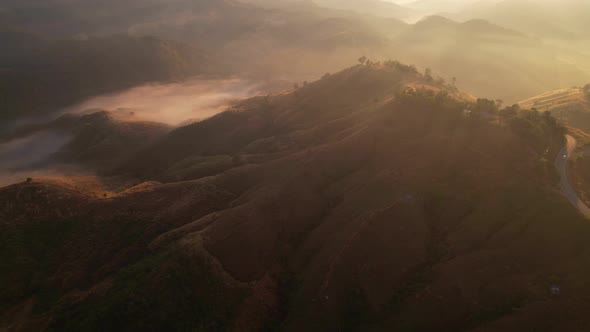 4K Aerial view from drone over mountains fog. Golden scenery at sunrise, Nan, Thailand alt