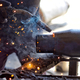 Unrecognizable industrial metalworker uses a heating tool to weld steel in his local repair shop  - PhotoDune Item for Sale