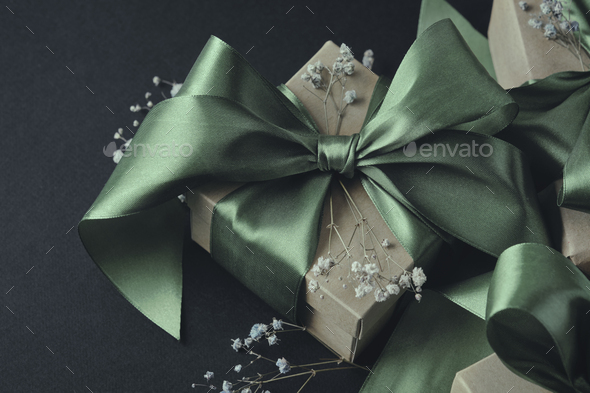 Paper gift box with olive green ribbon tied in a bow, small
