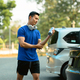 Male athlete in fitness clothes standing near his car while going to the gym. - PhotoDune Item for Sale
