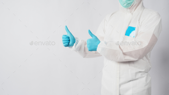 male model in PPE suite and face mask doing two thumbs up hand sign on white background.