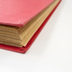 Close up of antique red book on white table - PhotoDune Item for Sale