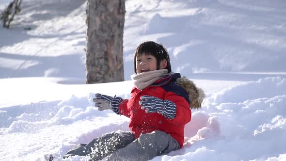 Cute Asian Child Wearing Winter Clothes Playing On Snow In The Park 08 alt