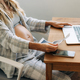 A pregnant woman working on a laptop looks an ultrasound of her baby. - PhotoDune Item for Sale