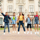 Happy Group Of Kids With Backpacks Holding Hands And Jumping Together Outdoors - PhotoDune Item for Sale