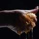Woman hand squeezes honeycombs full of honey. Dripping,pouring tasty sweet fluid - PhotoDune Item for Sale