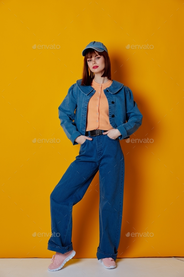 pretty woman stylish denim clothing posing color background