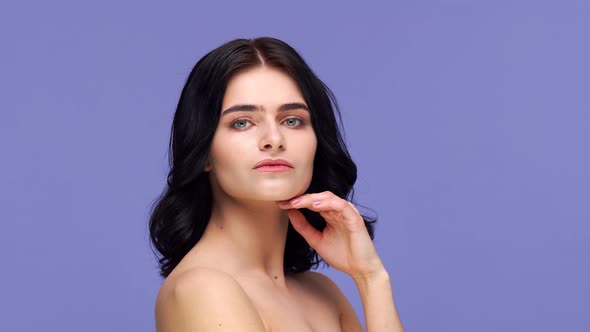 Studio portrait of young and beautiful brunette woman. alt